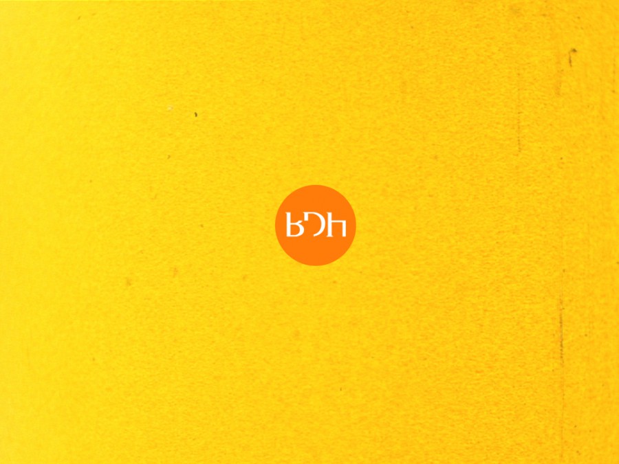a yellow background with an orange circle in the centre. In this are the letters BDH