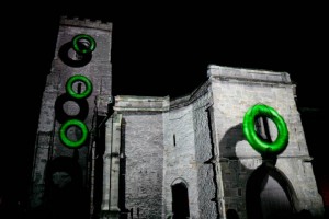Holy Trinity Church with projections on it - there are four green neon rings on the side of the church
