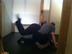 two male dancers on the floor moving in one of the rooms in the House