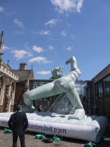 A grey inflatable, going up - you can see the legs and two small arms against a blue sky