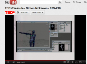 a screen shot of a youtube clip - its from a speech by simon mckeown - the screen shows a digitally animated body, with one arm outstretched.