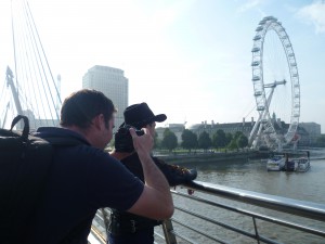 Jez being filmed on the bridge looking to the London Eye